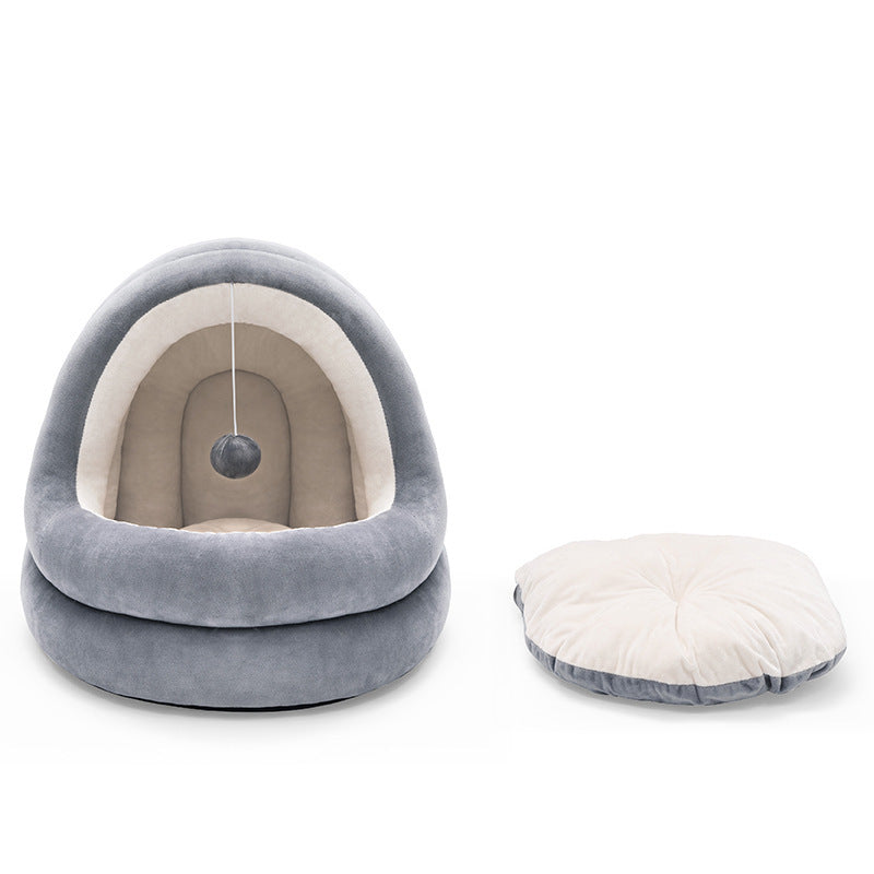 A cozy gray cat bed with a separate gray cushion