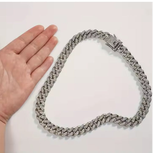 Hand holding sparkling silver luxury chain collar for dogs and cats showing size scale