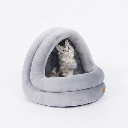 A cozy gray cat bed with a cat lounging. 