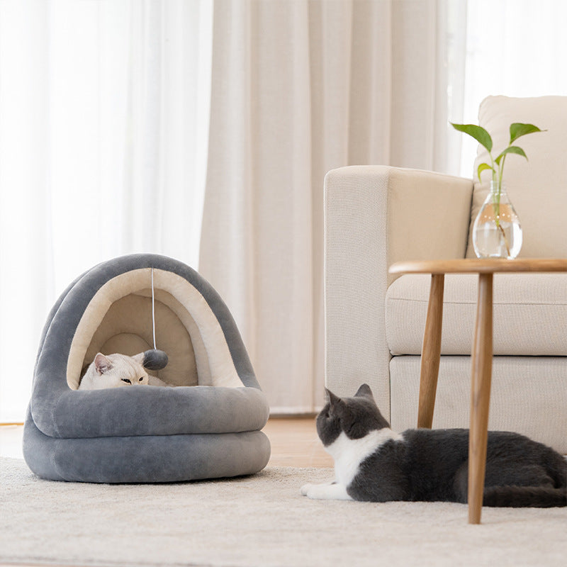 Two cozy gray cat beds with cats lounging, one awake and curious, the other peacefully sleeping. 