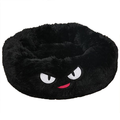 A cozy black cat bed with scary eyes 