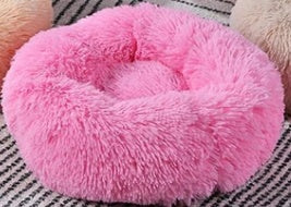 A cozy pink cat bed 