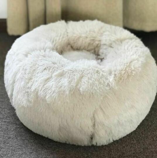 A cozy white cat bed 