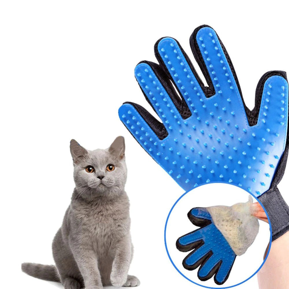 A person holds a Cat Grooming Glove, showing collected fur, with a curious cat in the background. 