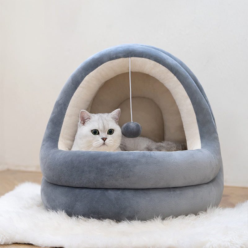 A cozy gray cat bed with a cat lounging. 