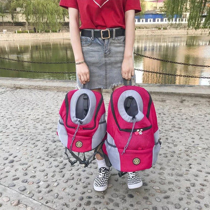 Girl holding two colorful Dog Backpacks near a calm water surface.