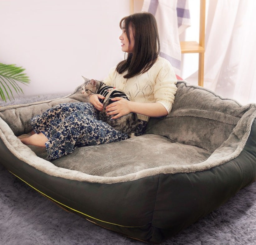 Dog Bed Collection showing a person in the dog bed with their dog. 