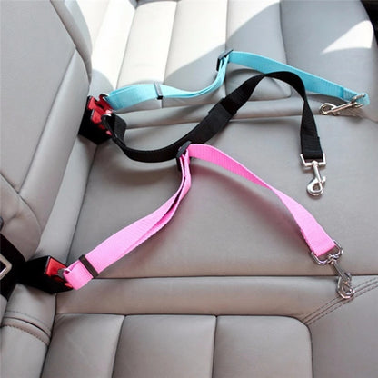 A gA pink and green  seatbelt harness, secured in the backseat of a car.