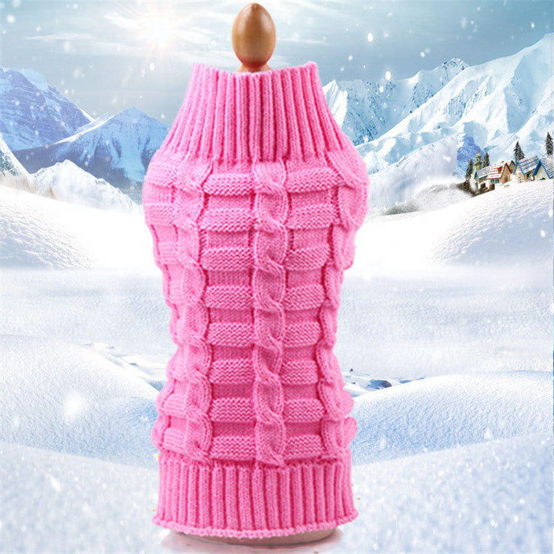 Cozy Pink Dog Sweater against a snowy mountain backdrop. 