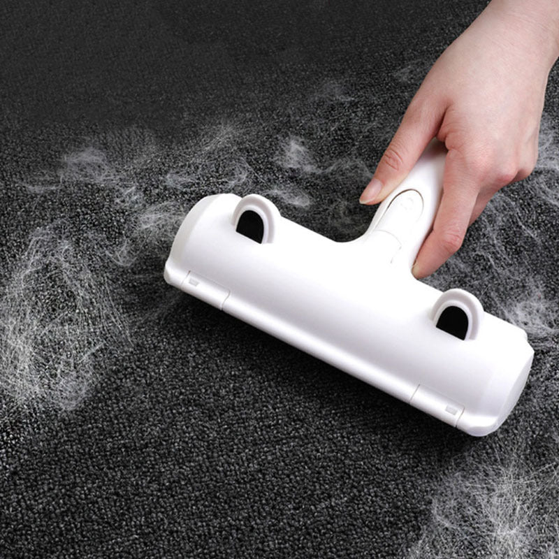 Hand holding a white Pet Lint Roller over a dark carpet, removing pet hair.