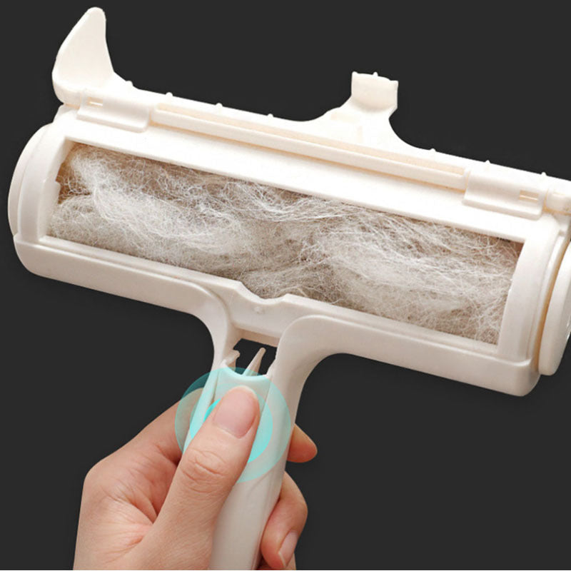 Hand holding a white Pet Lint Roller over a dark carpet, removing pet hair.